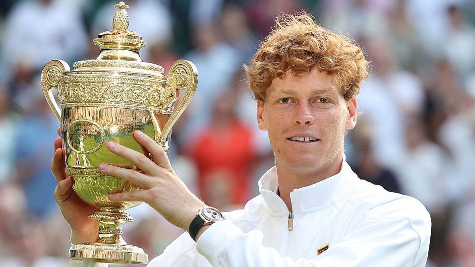 Jannik Sinner with the Wimbledon men's trophy