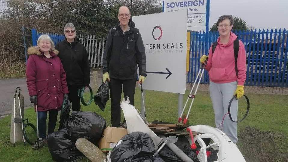 A group of people around some rubbish