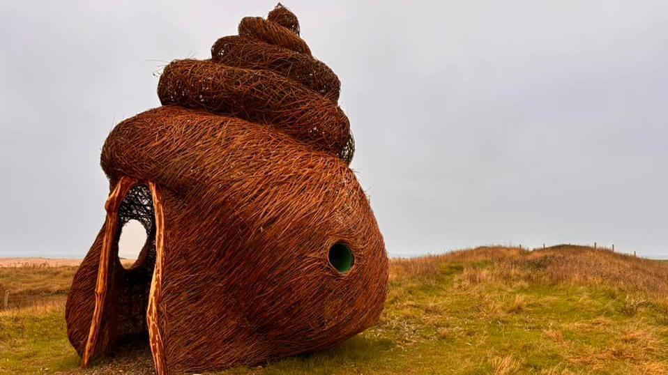 The periwinkle-shaped structure on an RSPB nature reserve near Chichester, made of branches twisted into the shape of a shell.