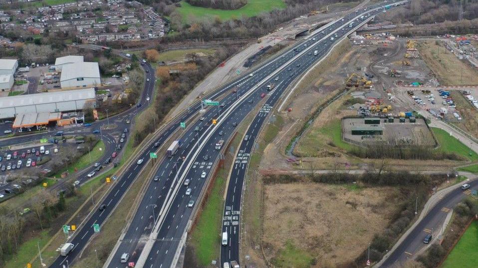 A drone shot of the Western bypass with the new Allerdene Bridge in the distance and construction work to the right.