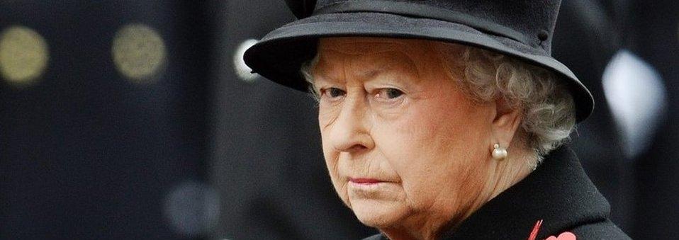 The Queen dressed in black jacket and black hat