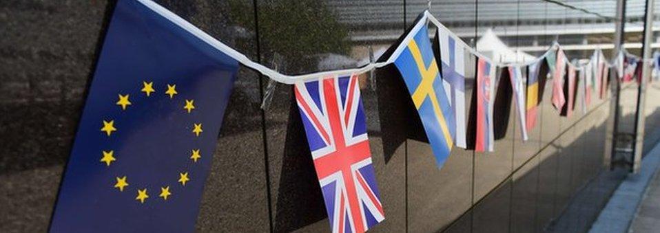 EU and Union flags outside the European Commission in Brussels