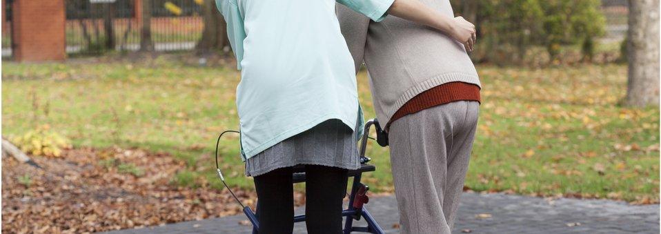 Woman being helped to walk