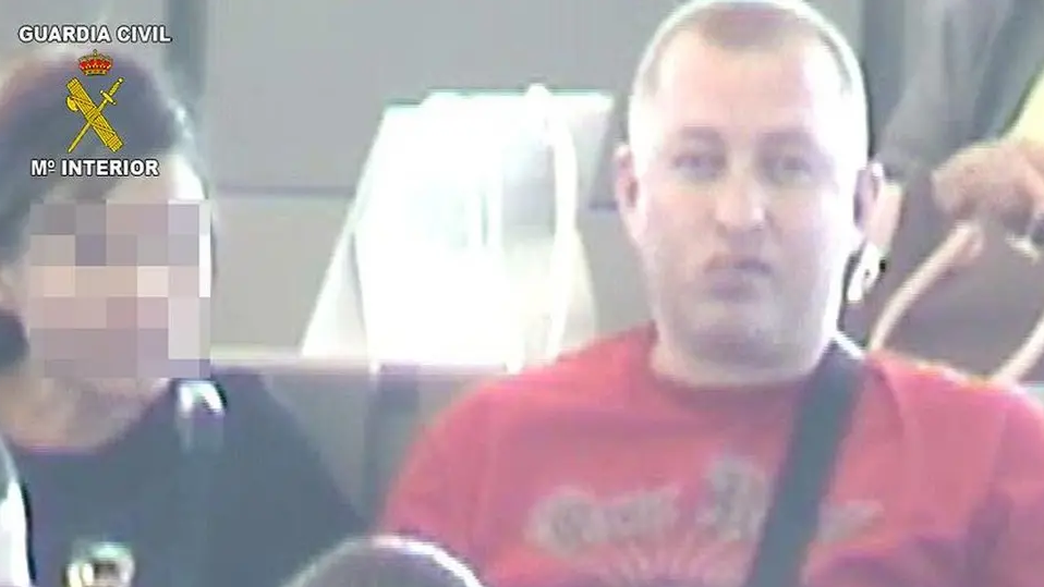 Robert Dawes, pictured in a red T-shirt, during his arrest 