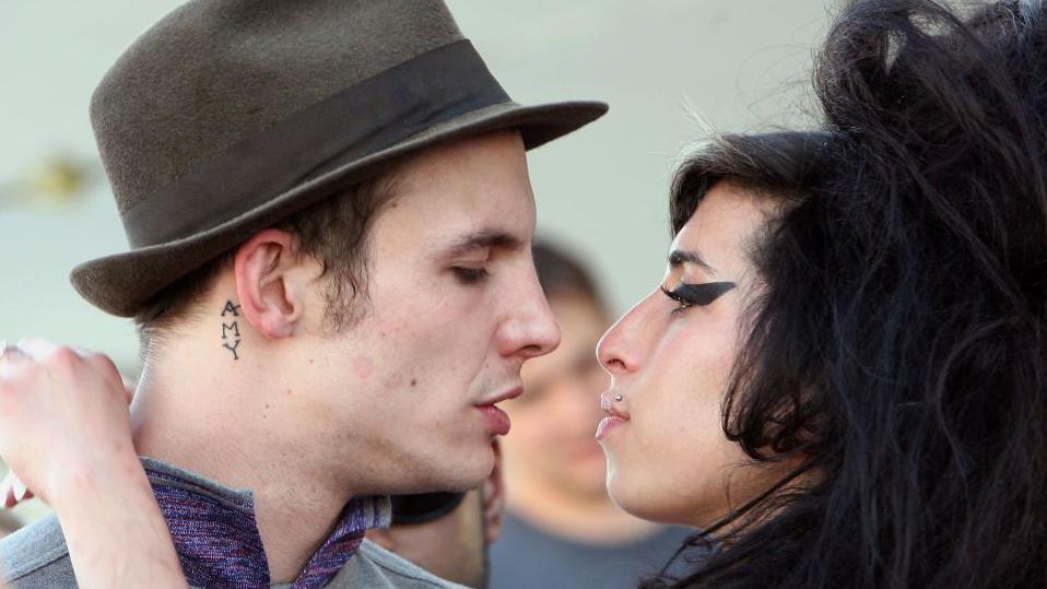 Singer Amy Winehouse kisses fiance Blake Fielder-Civil during day 1 of the Coachella Music Festival held at the Empire Polo Field on April 27, 2007 in Indio, California.