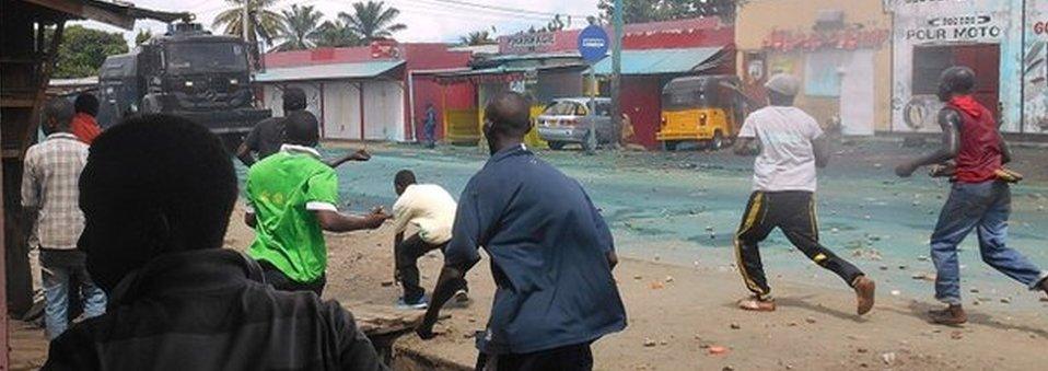 Protesters throw rocks during clashes with police in Cibitoke, north-western Burundi, on April 26, 2015