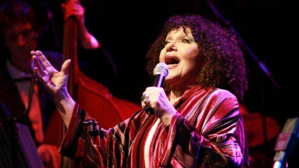 Cleo Laine singing during her heyday, on stage in a flowing dress