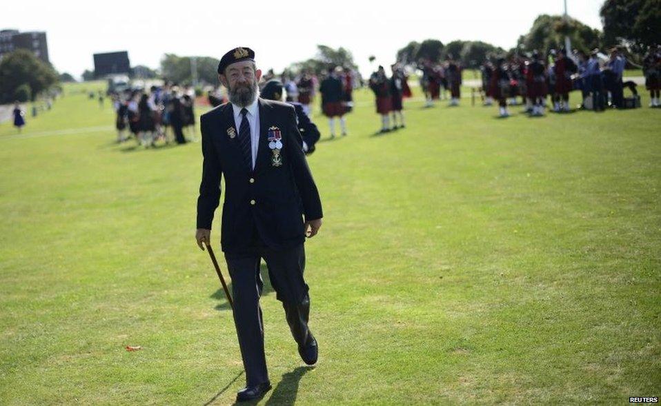 A veteran arrives at a parade in Folkestone, Kent, to mark Monday's anniversary