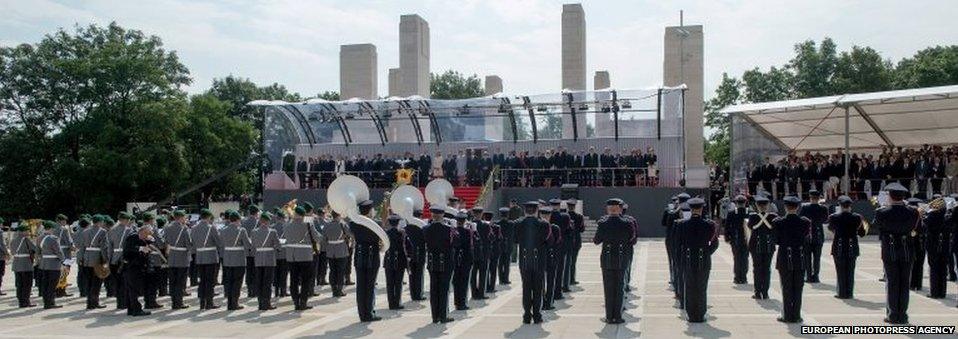 Bands from Germany, dressed in grey, and Belgium (right) performed for dignitaries attending the ceremony in Liege.