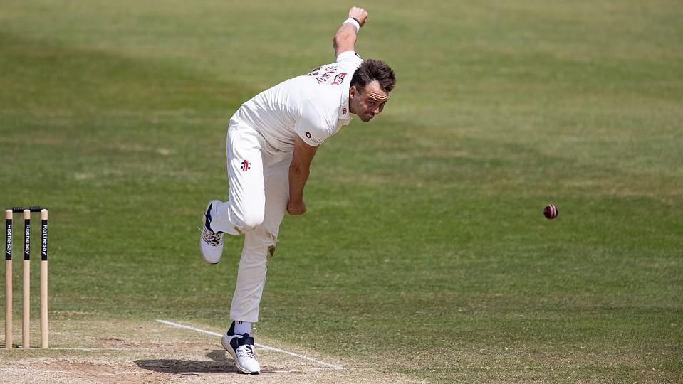 Harry Conway releases the ball on his follow through during an over for Northamptonshire