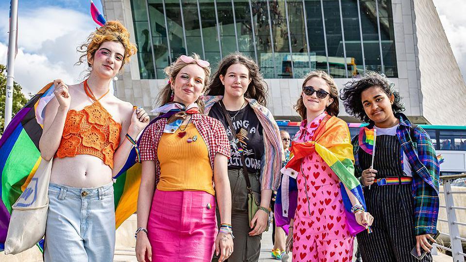 People wearing bright clothes and enjoying Liverpool Pride