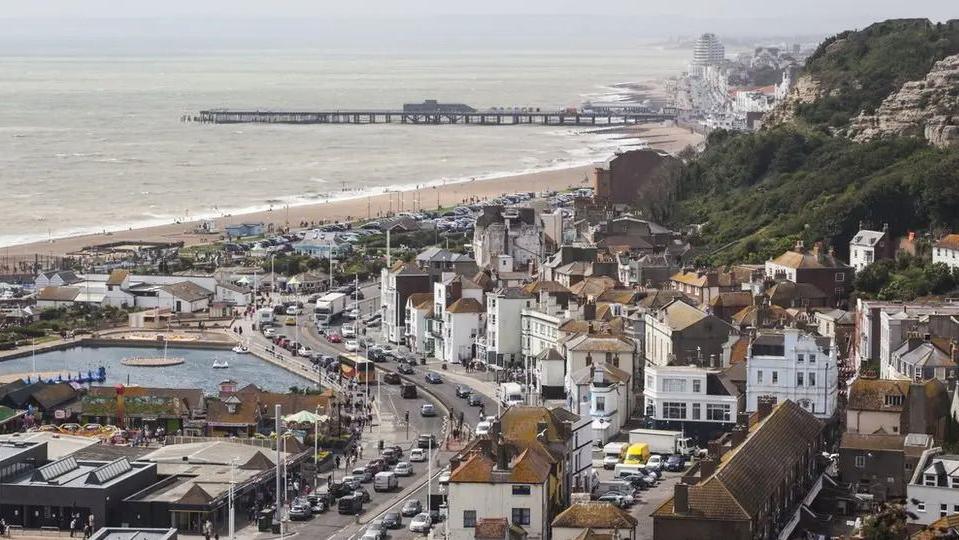 An view of Hastings from above, showing the beach, pier and town centre