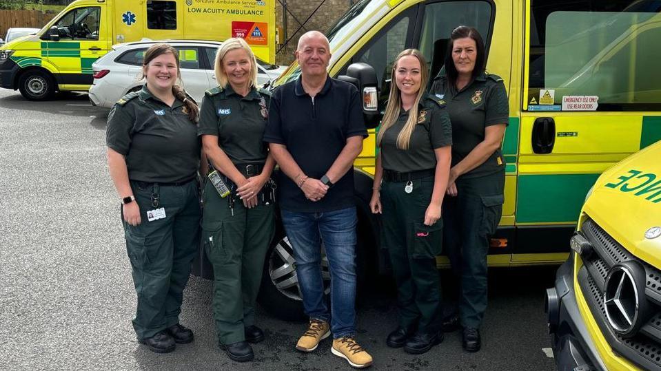 Castleford ambulance care assistant, Mark Spedding, standing with the Wakefield and Castleford paramedics who saved his life