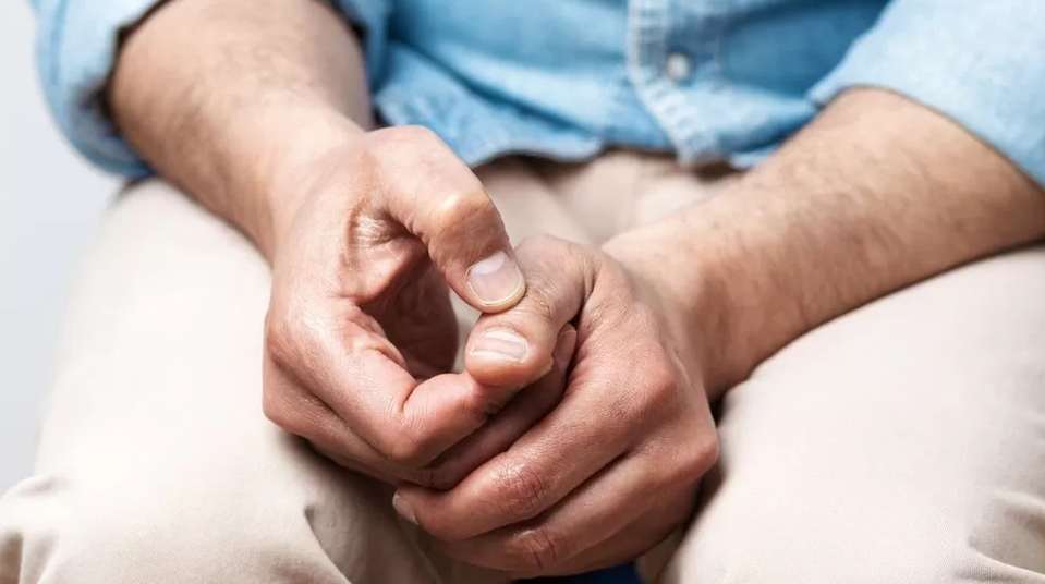 Person sitting with hands in lap