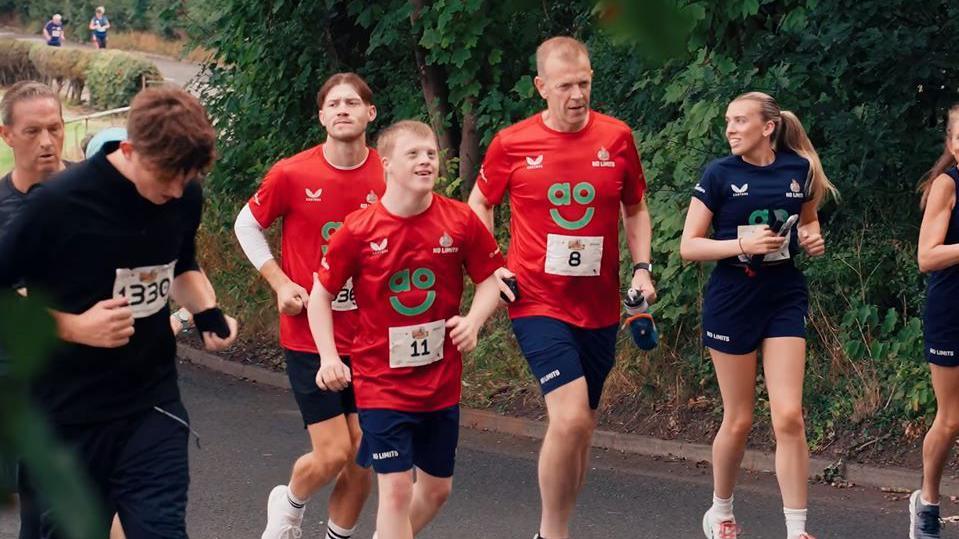 Joseph Adams ran accompanied by his friends and family