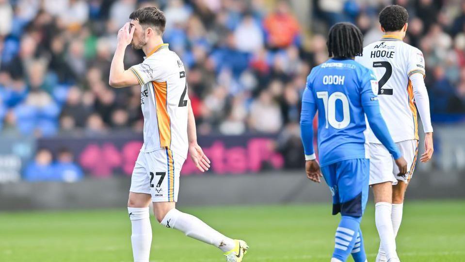 Shrewsbury striker John Marquis was sent off in the first minute at Peterborough for a stray elbow