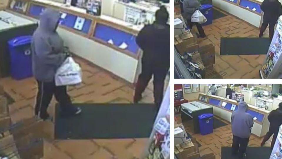 CCTV footage of a woman wearing a large blue hoodie and blue trousers at a parcel dispatch centre. She is holding a white carrier bag. A bystander stands in front of her in the queue.