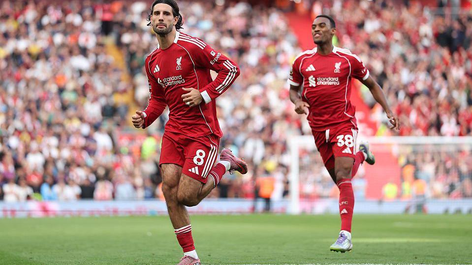 Dominik Szoboszlai turns away in triumph after giving Liverpool the lead against Arsenal