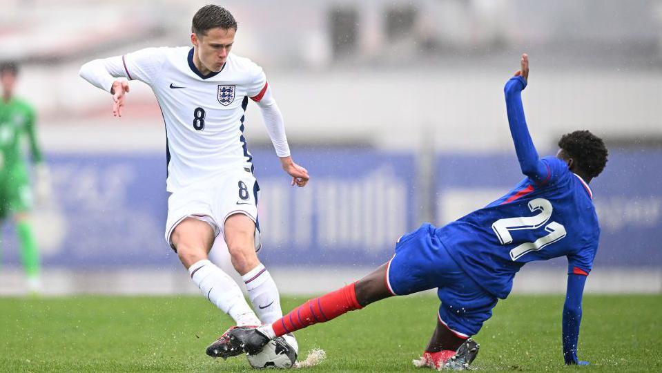 Harrison Armstrong (left) is challenged by Junior Ake while playing for England Under-18 against France in March