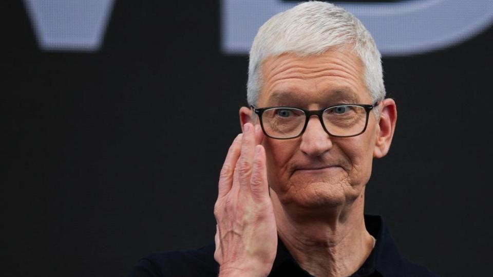 Apple CEO Tim Cook touches his hand to his face while on stage during Apple's annual Worldwide Developers Conference in Cupertino, California, U.S.