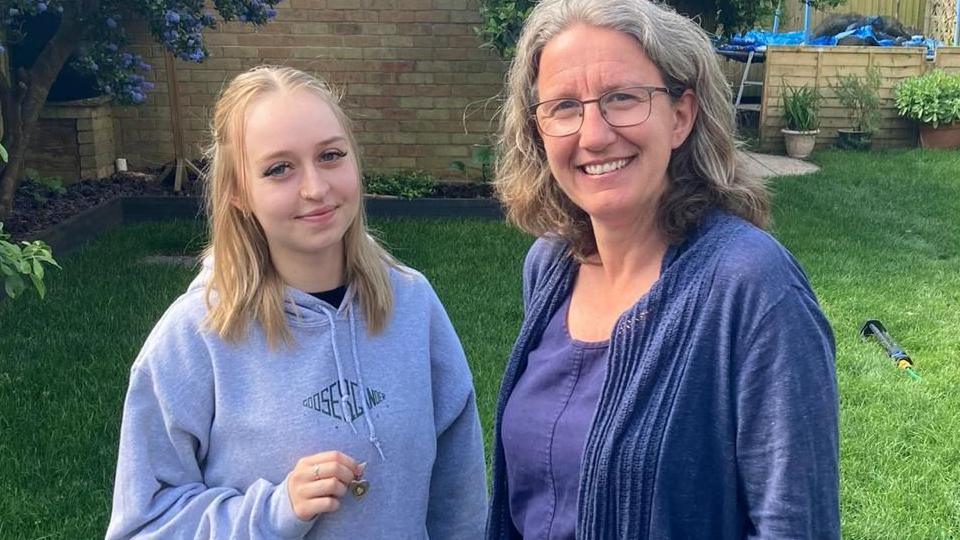 Claire Stonier with Nicole Parker who is holding the pendant containing her great-grandfather's photograph