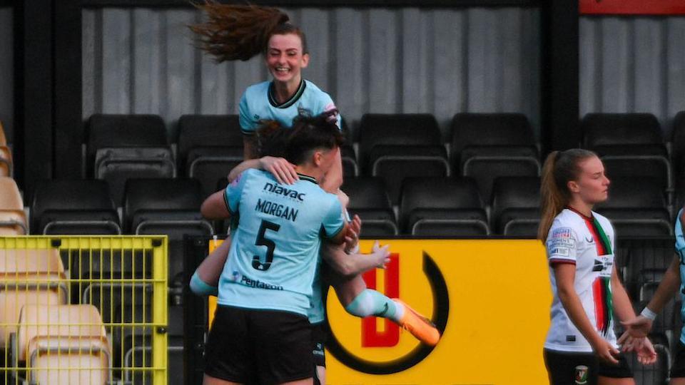 Caitlin McGuinness celebrates a goal for the new champions