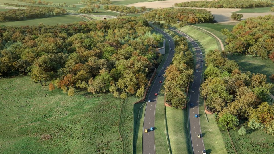 An image provided by Norfolk County Council showing how a section of the Western Link could look. It shows a number of cars o two curving lanes running through the countryside, with a mixture of fields and trees surrounding them.