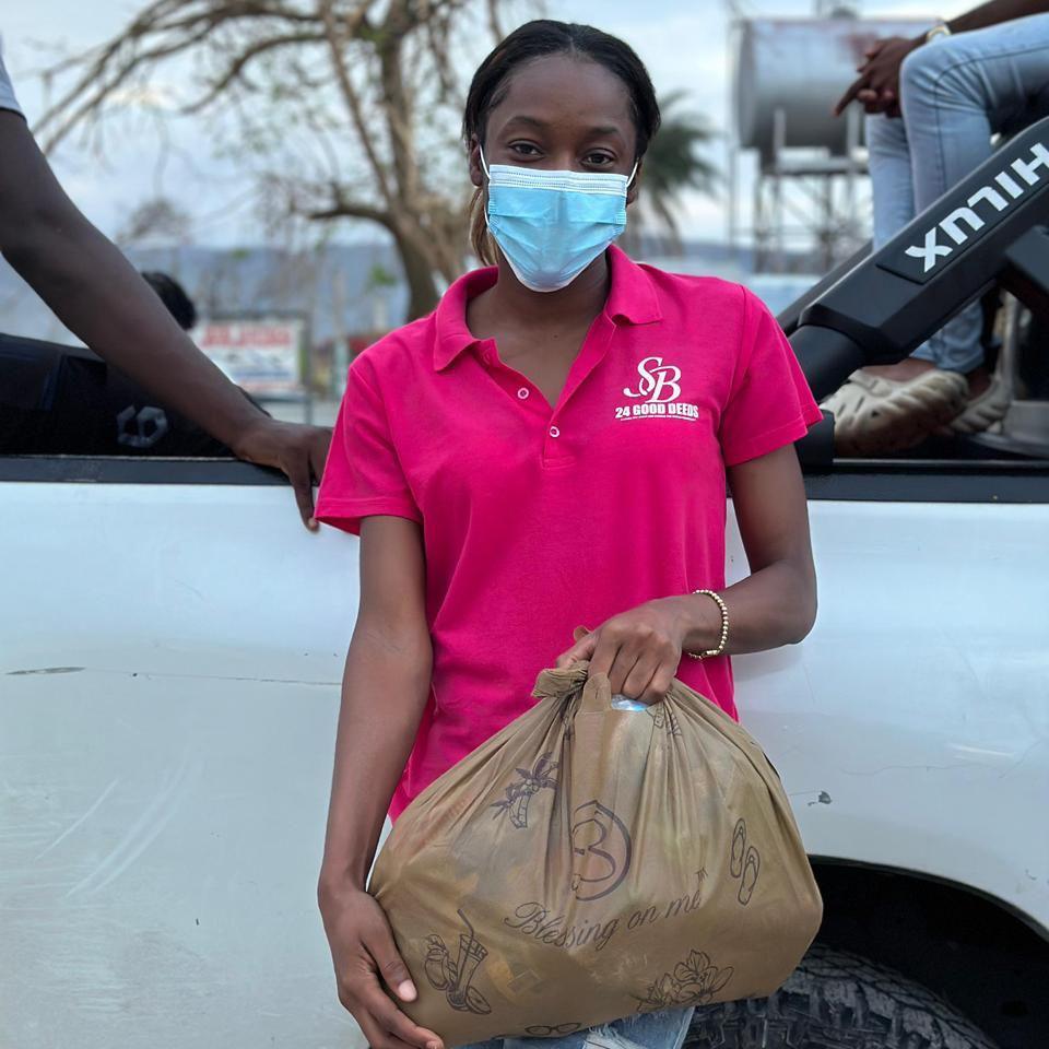 Jamaica netball player Shanice Beckford holds an aid package
