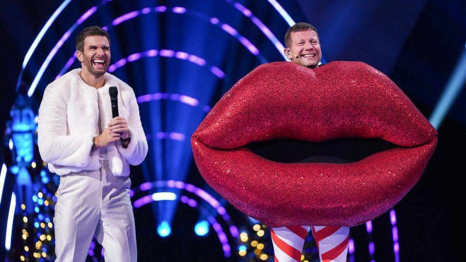 Masked Singer host Joel Dommett and presenter Dermot O'Leary dressed as some lips