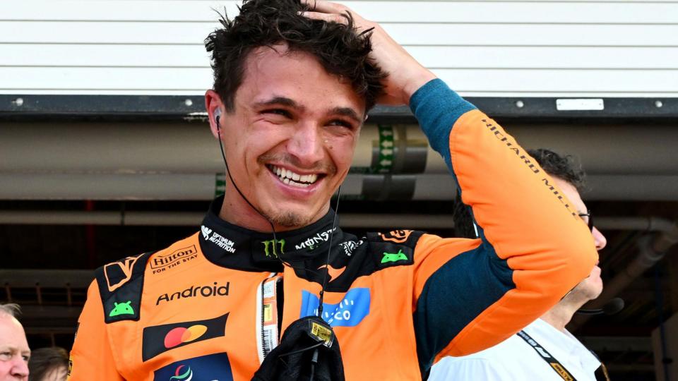 Lando Norris smiles as he runs his hand through his hair after taking pole position for the Miami Grand Prix sprint race