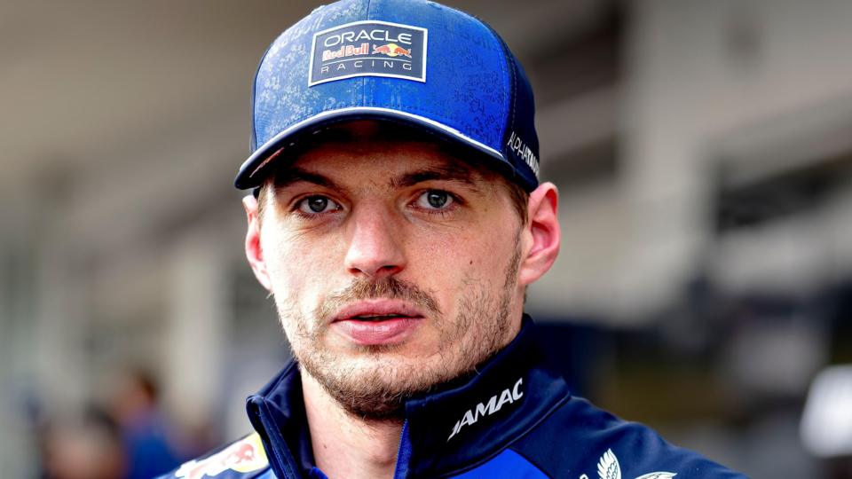 Max Verstappen wearing a blue Red Bull cap and staring straight ahead at the 2026 Japanese Grand Prix