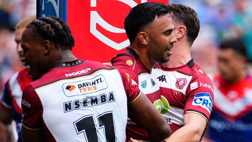 Wigan's Bevan French celebrating scoring a try with his teammates.