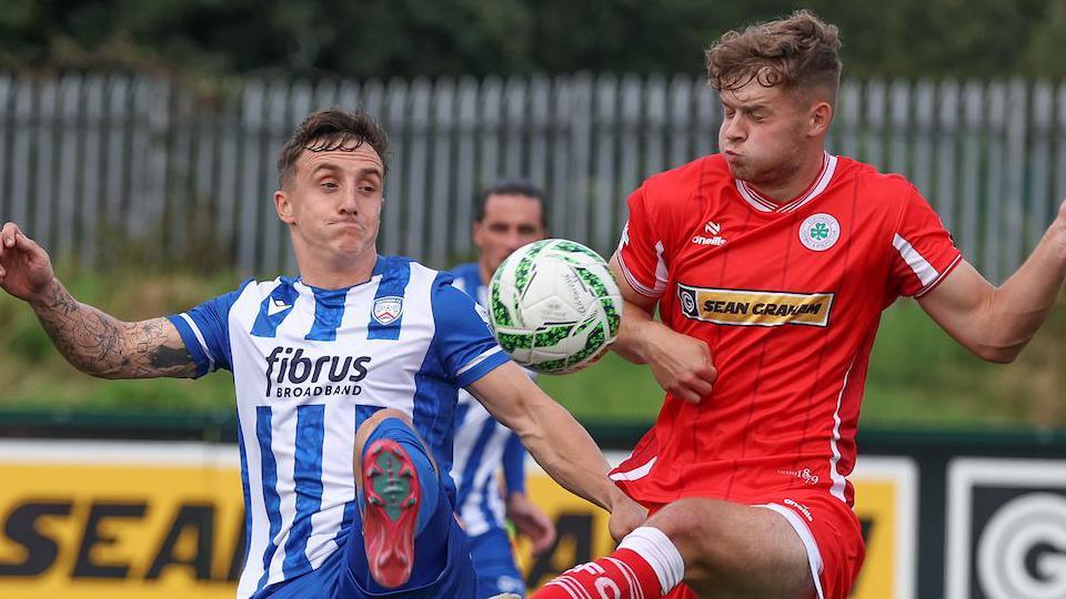 Coleraine's Joel Cooper in action against Harry Wilson of Cliftonville