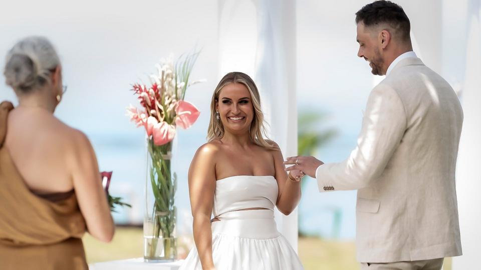 A couple stand at the altar of a wedding ceremony
