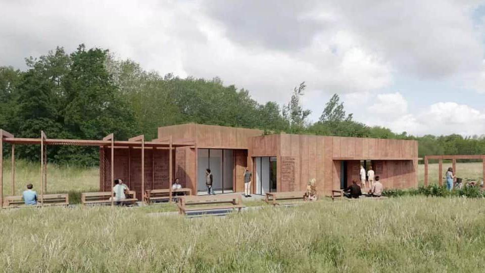 An artist's impression of a new visitor centre at the Bennerley Viaduct site. It shows the exterior of a one-storey building with outdoor seating and a wooden canopy on the left. 