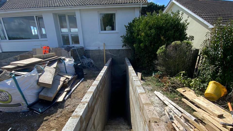 Building material is place either side of the entrance to a German wartime bunker found under a house in Guernsey.