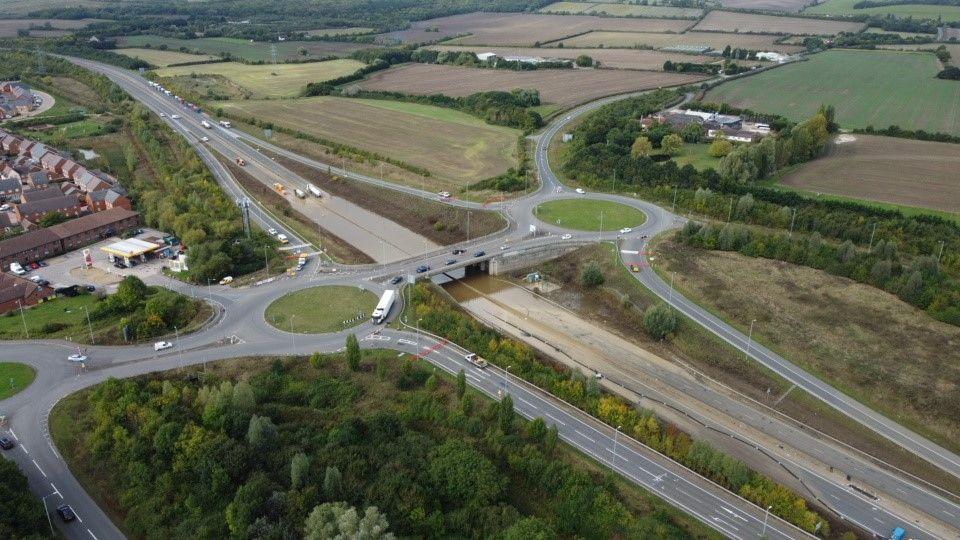 The A421 aerial shot, showing the road, water on the road and the surrounding roads and slip lanes