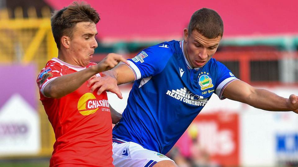 Shelbourne's James Norris in action against Ethan McGee of Linfield