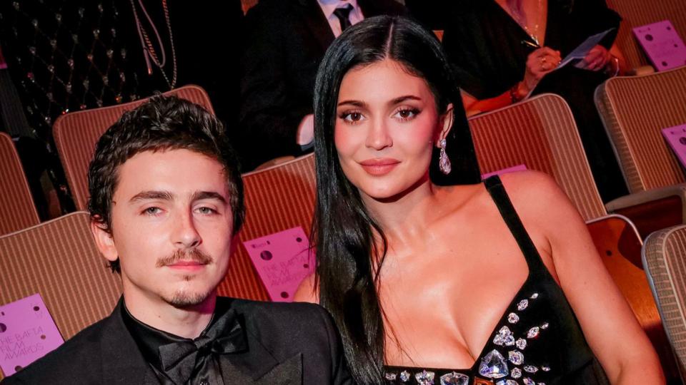 Timothée Chalamet and Kylie Jenner in black, smart outfits.