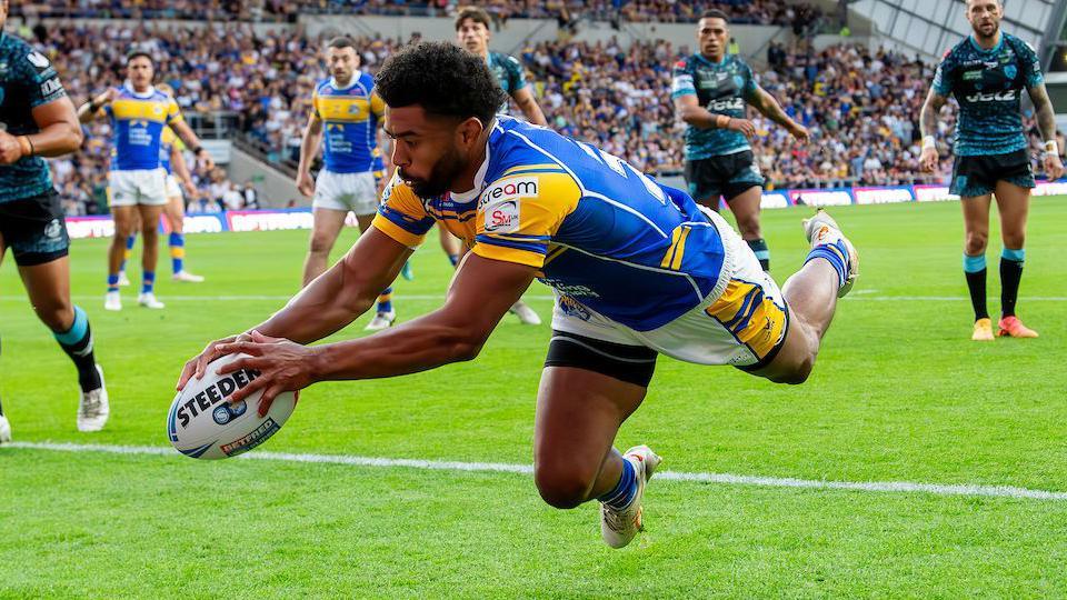 Leeds Rhinos player Kallum Watkins dives over to score a try against Leigh Leopards