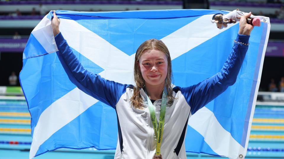 Katie Shanahan with a bronze medal and Scotland flag at Birmingham 2022
