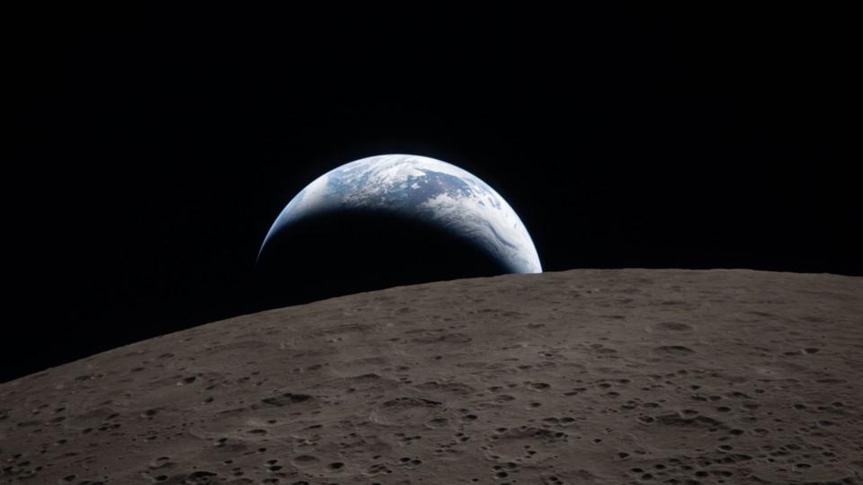 Earth poking out from behind the cratered surface of the Moon.