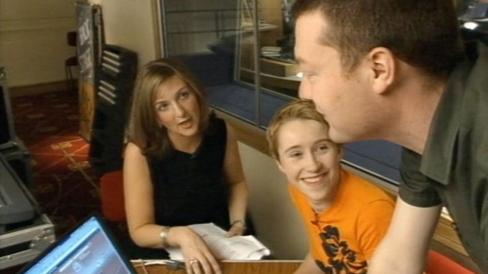 Victoria Derbyshire, a boy and Charlie Brooker having a conversation next to a laptop in 1999
