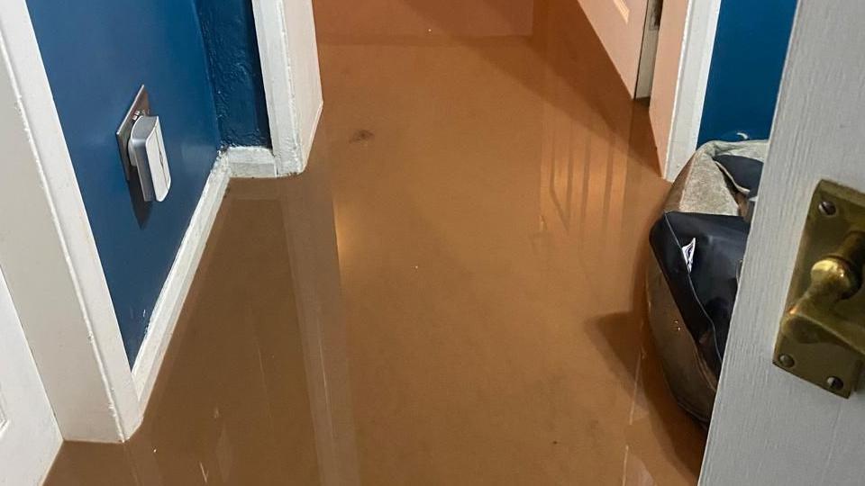 The picture shows inside the home owned by Anna Mimms. The floor of a hallway is covered in flood water during Storm Babet in October 2023