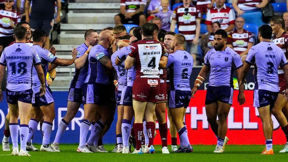 Wigan and Hull KR players gather at a flashpoint in the first half