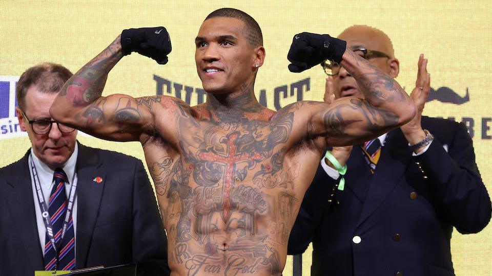 Conor Benn holds out his arms