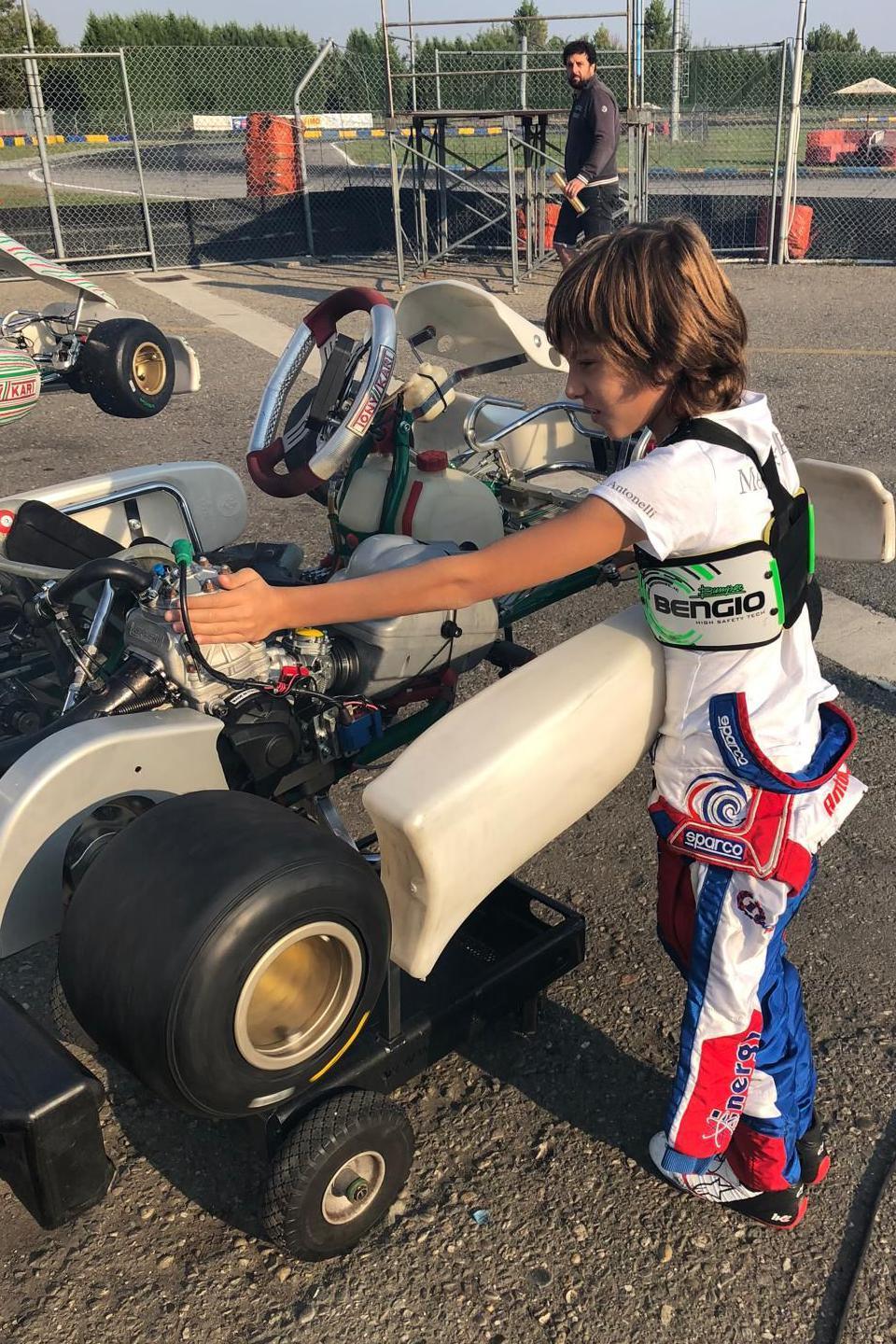 Kimi Antonelli, aged about 10 or 11, carrying a go-kart