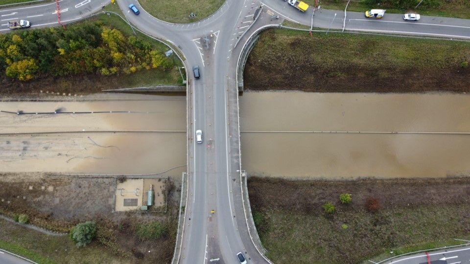 An aerial shot of the A421 showing a bridge and a road full of flood water 