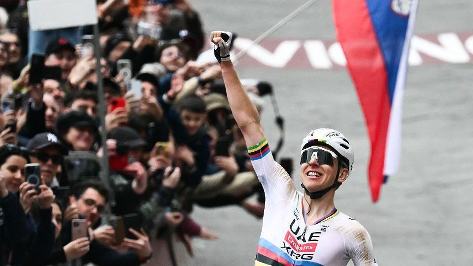 Tadej Pogacar celebrates winning the 2026 Strade Bianche