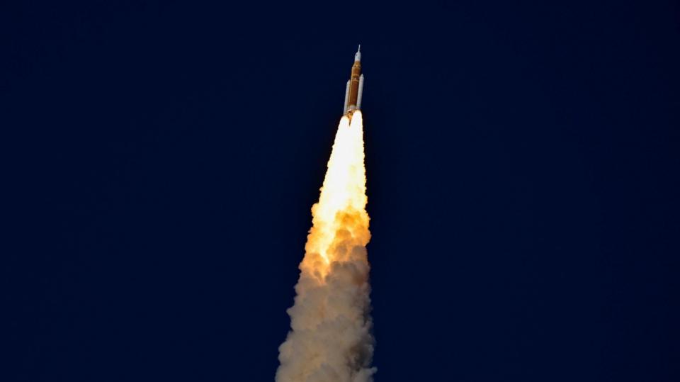 Spacecraft seen against dark skies, shooting up into the air
